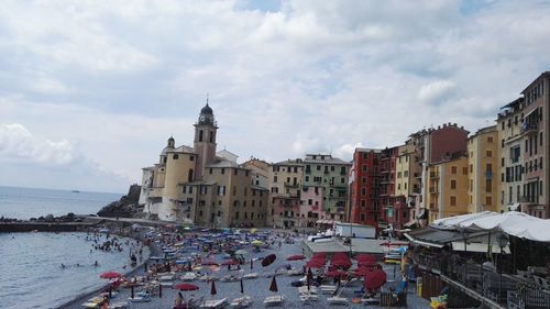 Panoramic view of sea by city against sky