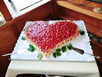 High angle view of heart shape cake served on table