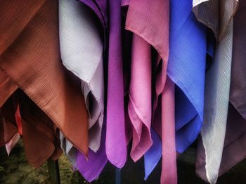 Close-up of multi colored clothes hanging for sale 