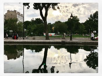 Reflection of trees in lake against sky