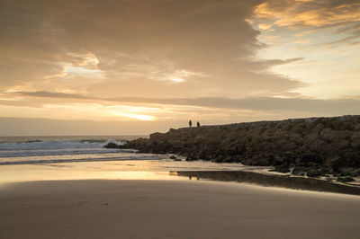 Scenic view of beach against sky during sunset