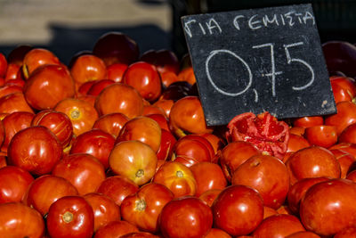 Close-up of fresh tomatoes with price tag at market