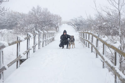 Rear view of person on snow covered trees during winter