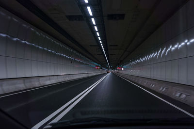 Low angle view of illuminated lights in tunnel