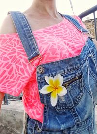 Midsection of woman holding flower