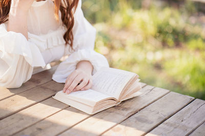 Young woman reading book