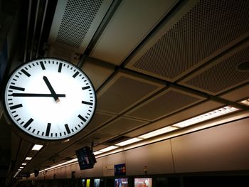 Low angle view of illuminated clock at railroad station