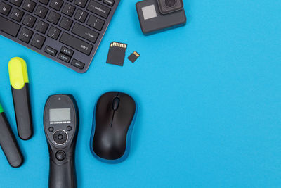 High angle view of mobile phone on blue table