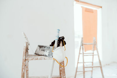 Ladders and tools on white room at construction site. painting walls. home improvement, renovation