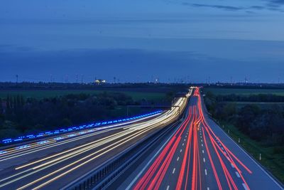 High angle view of light trails on road at night