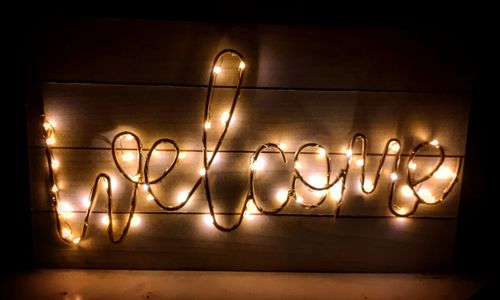 Low angle view of illuminated lighting equipment on wall