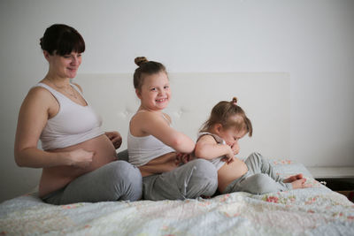 Pregnant mother with daughters, life style in a real interior. the concept of large families 