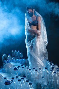 Worried woman surrounded and trapped in format. concept of recycling plastic. vertical format.