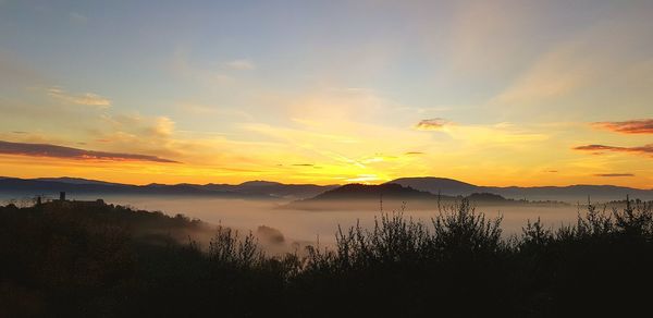 Scenic view of lake against sky during sunset