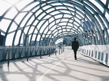 Full length of woman walking in tunnel