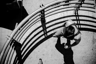 Full length of woman standing on railing