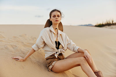 Young woman sitting at beach