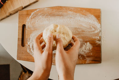 Cropped hands kneading dough 