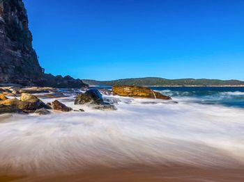 Scenic view of sea against clear blue sky