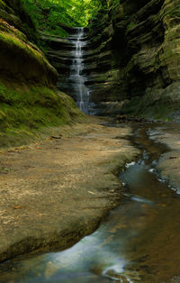 Scenic view of waterfall against sky