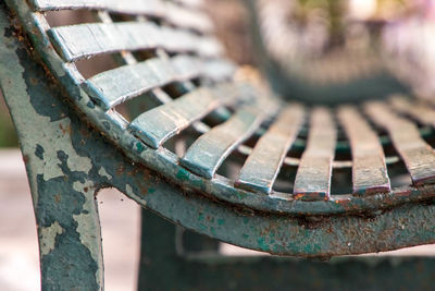 Close-up of rusty metal bench