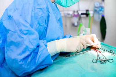 Midsection of doctor examining patient in hospital