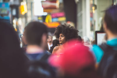 Rear view of people enjoying music in city