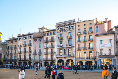 Group of people against buildings in city