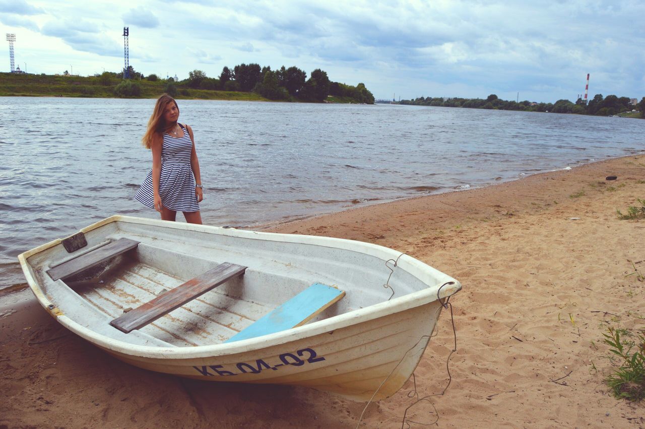 water, nautical vessel, boat, transportation, mode of transport, moored, sea, sky, shore, beach, river, lake, day, tranquility, one person, outdoors, nature, tranquil scene, sand, riverbank