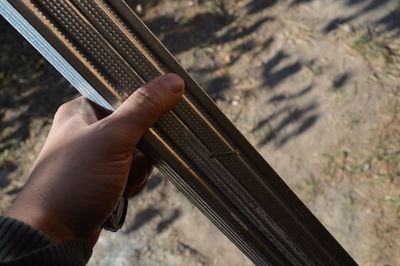 Close-up of person hand holding metal