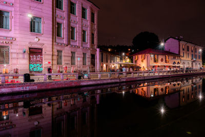 Reflection of illuminated buildings in canal at night