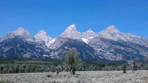 Scenic view of mountains against clear blue sky