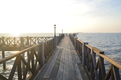 Pier over sea against sky