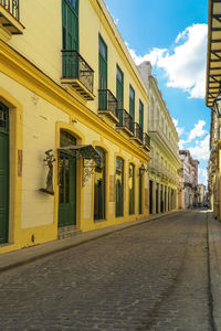 Street amidst buildings in city against sky