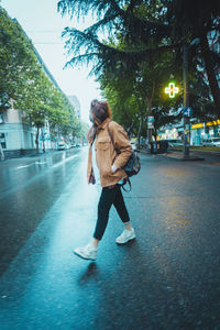 Full length of man walking on street in city