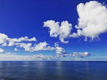 Scenic view of sea against blue sky