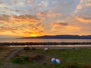 Scenic view of beach against sky during sunset