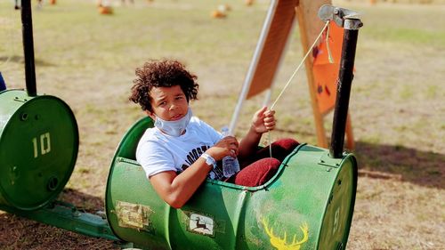 Portrait of smiling boy sitting on playground