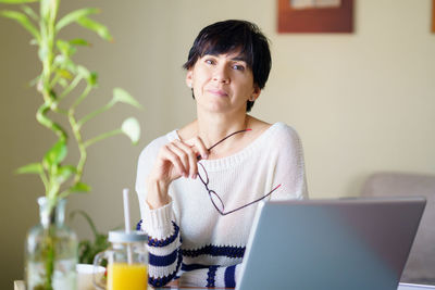 Woman using laptop while sitting at home