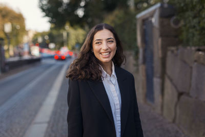 Smiling businesswoman looking away