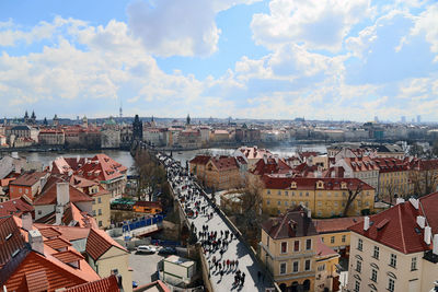 View of cityscape against cloudy sky