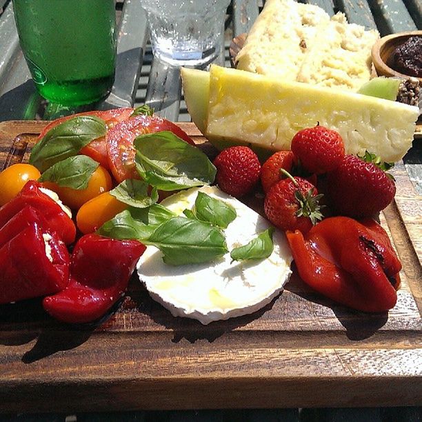 food and drink, food, freshness, healthy eating, indoors, table, vegetable, still life, tomato, fruit, high angle view, red, ready-to-eat, salad, strawberry, slice, plate, variation, cutting board, organic