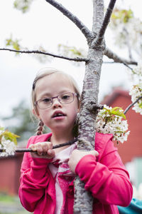 Portrait of cute girl with pink flower