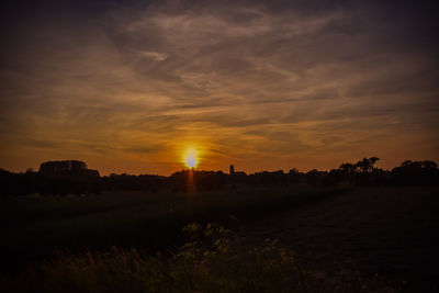 Scenic view of field against sky during sunset