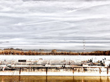 Scenic view of river against sky during winter