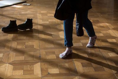 Low section of women on floor at home