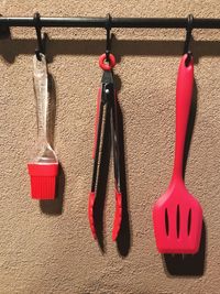 Kitchen utensils hanging against wall