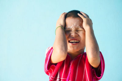 Boy against blue background