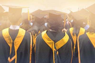 Rear view of students wearing graduation during ceremony