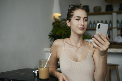 Portrait of young woman using smart phone